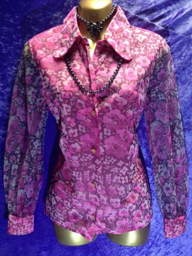 Pink floral patterned shirt with long sleeves and a button-down front.